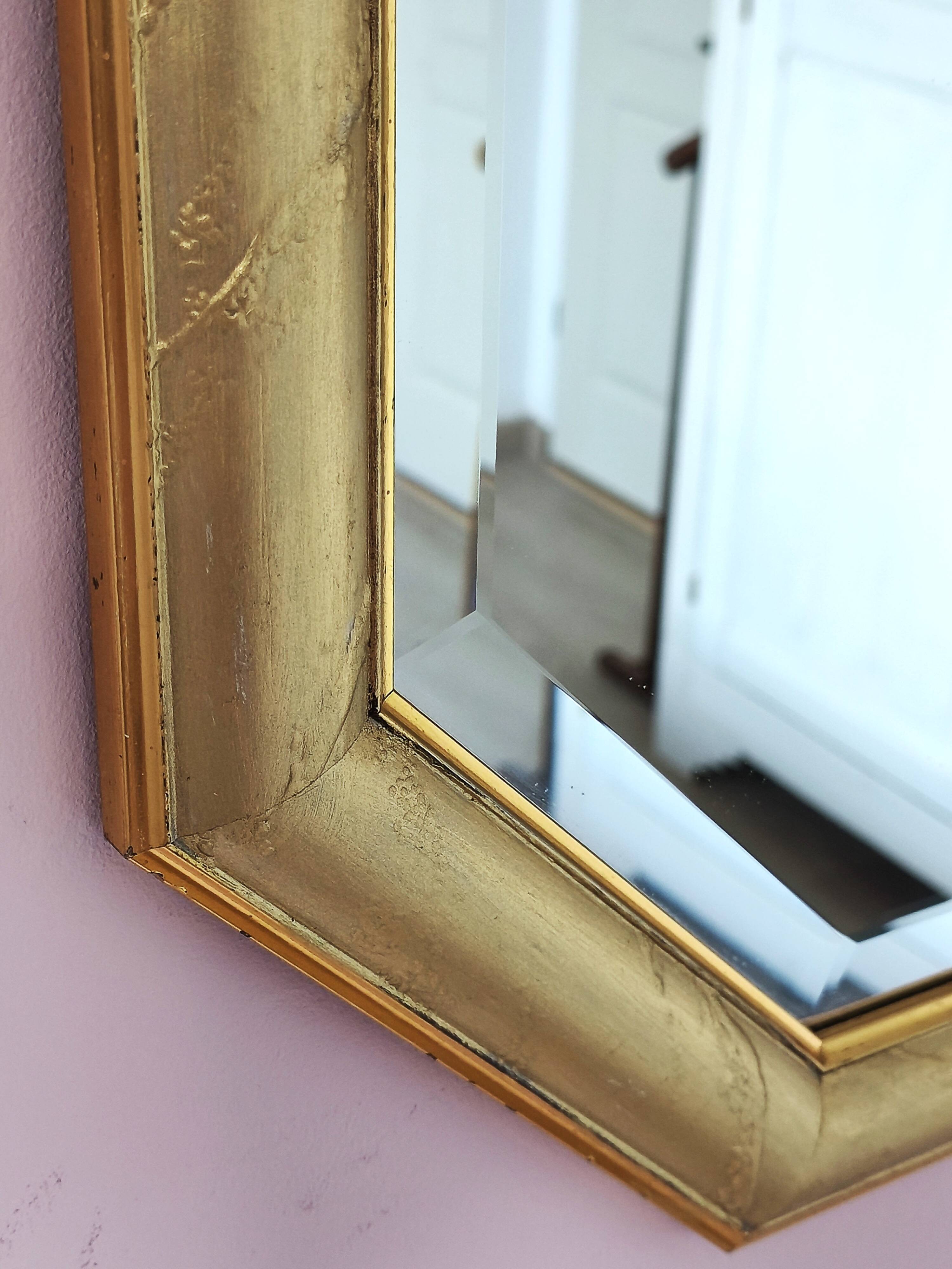 Golden octagonal mirror with bevelled glass from the 1970s.