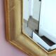 Golden octagonal mirror with bevelled glass from the 1970s.