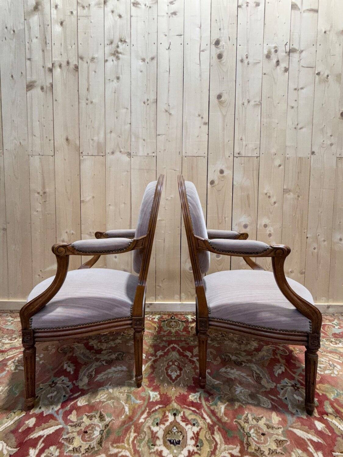 Pair of Louis XVI cabriolet armchairs with medallion backrest.