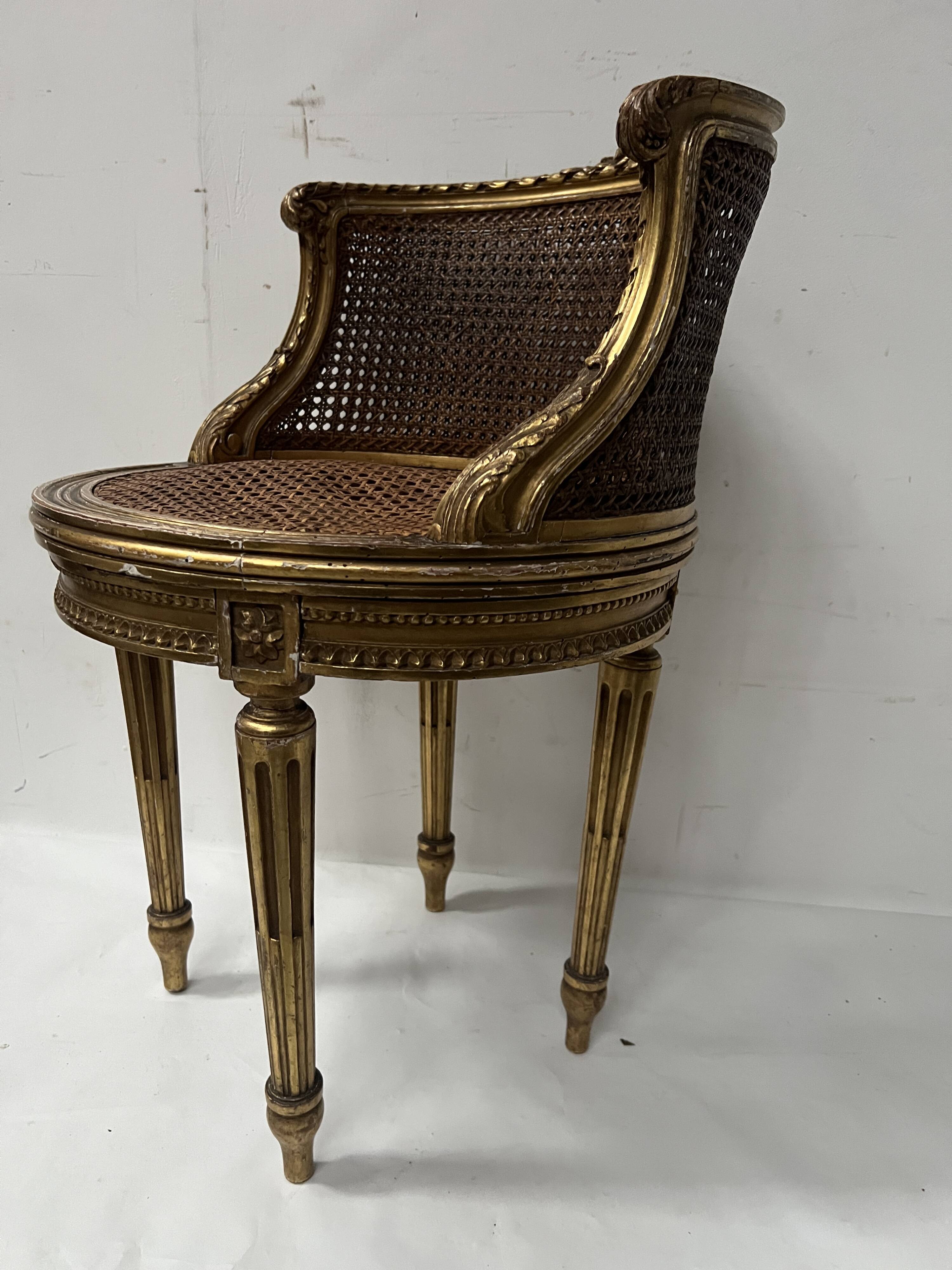 Louis XVI style armchair in wood and gilded stucco, 20th century.