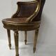 Louis XVI style armchair in wood and gilded stucco, 20th century.