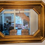 Antique octagonal mirror in gilded wood with painted floral decoration.