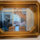 Antique octagonal mirror in gilded wood with painted floral decoration.