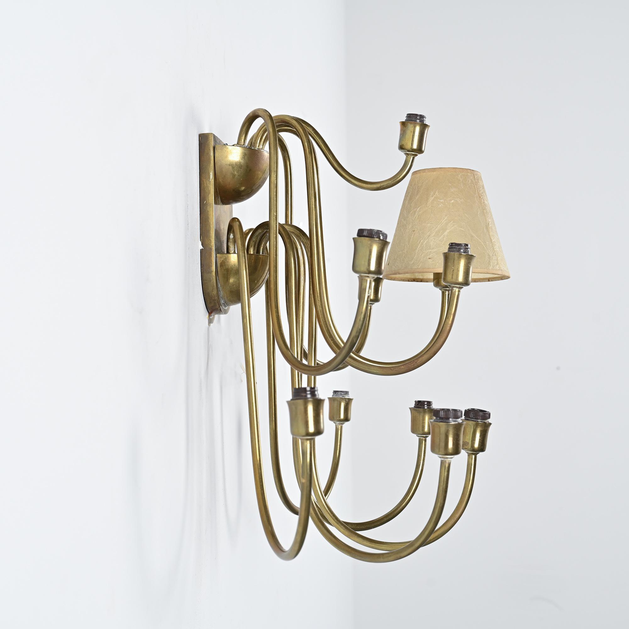 Wall sconce with nine arms in brass, France, circa 1950.