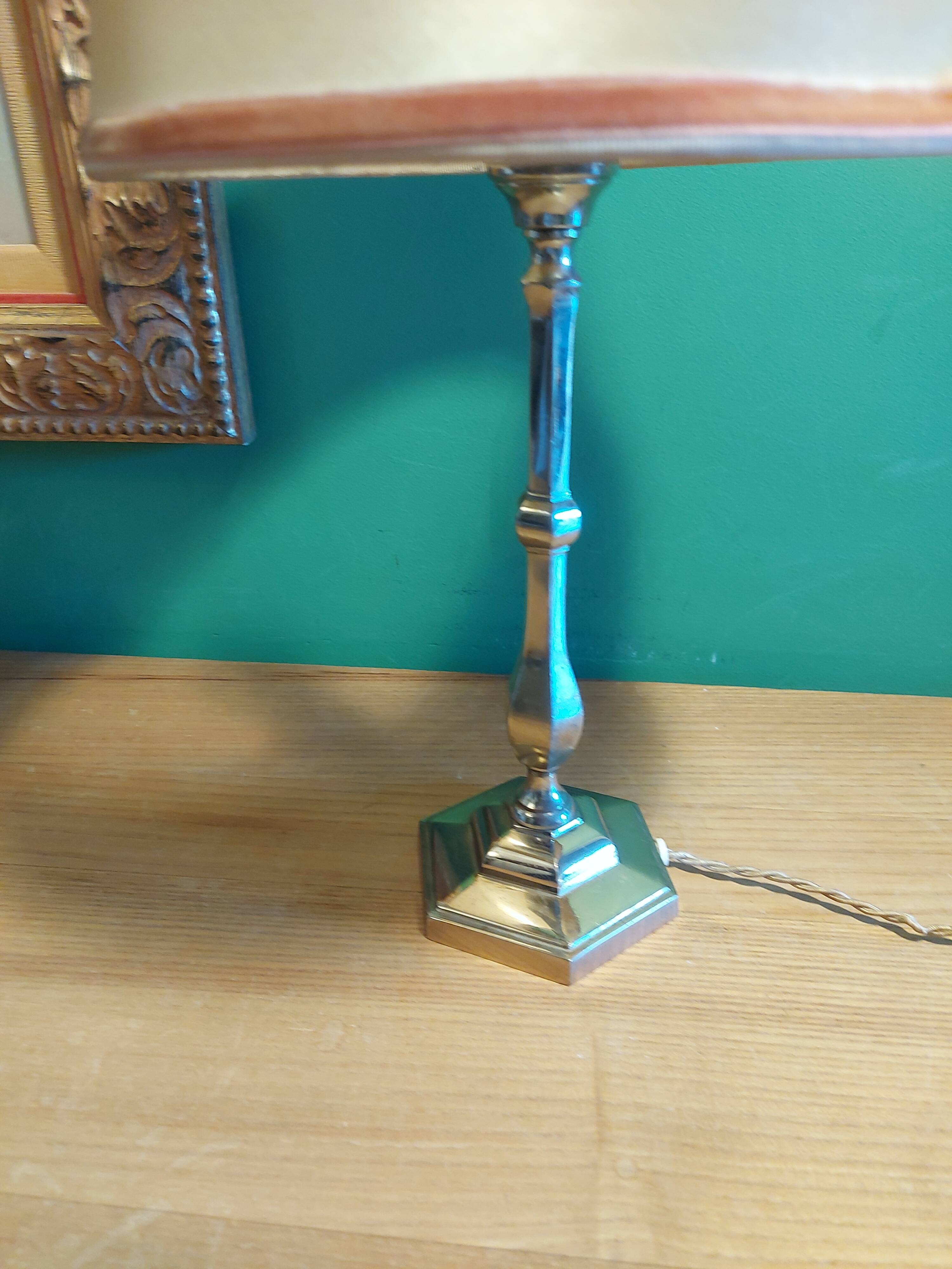 Silver metal lamp with its lampshade
