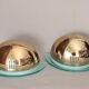 Pair of gold metal and plexiglass wall lights, circa 1980.