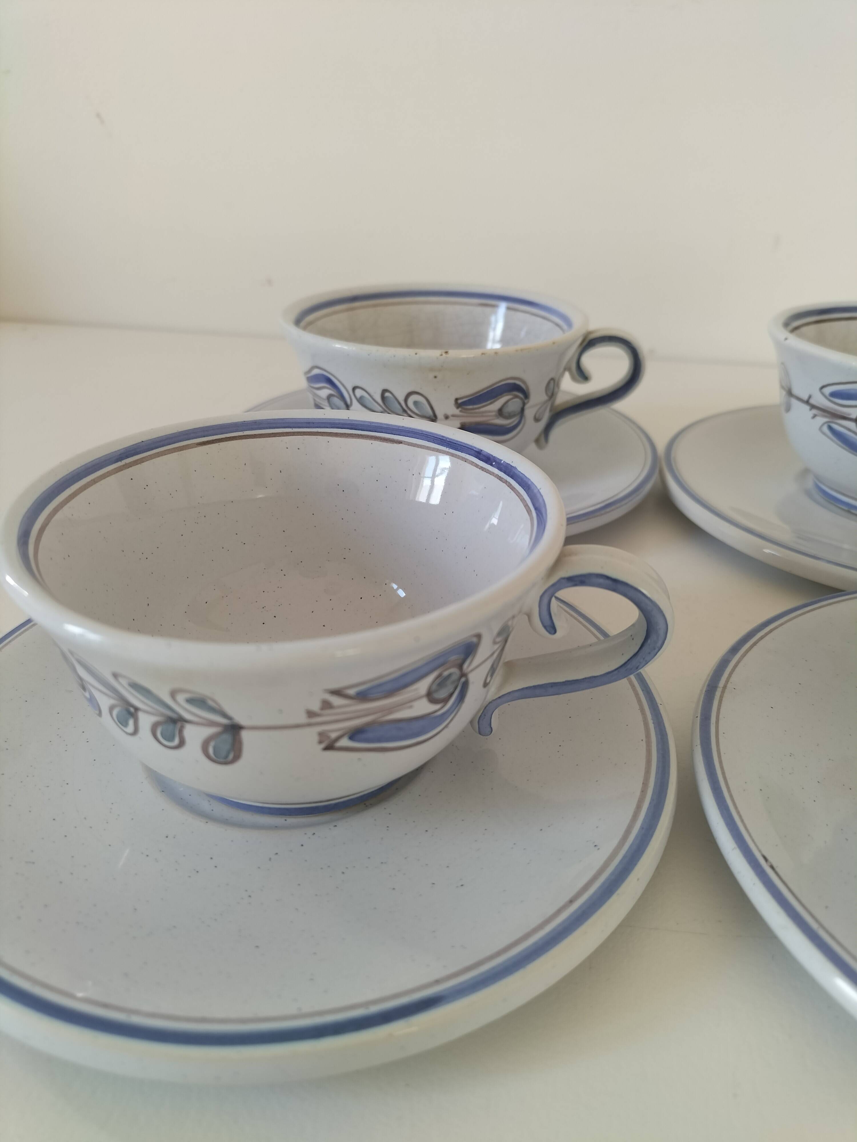 Glazed earthenware cups and saucers