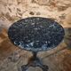 Old French bistro table with a marble top and a cast iron base.