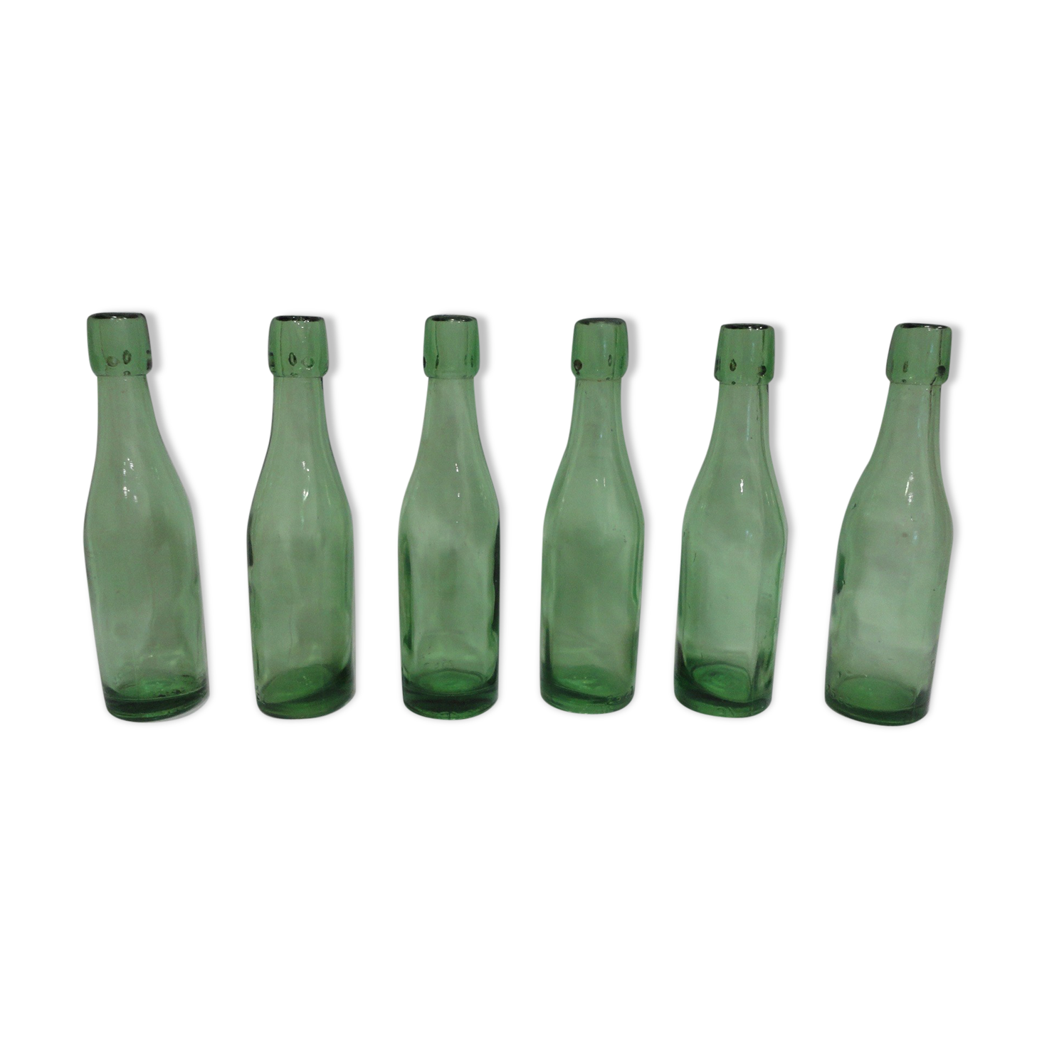 Series of 6 old glass soda bottles