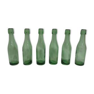 Series of 6 old glass soda bottles