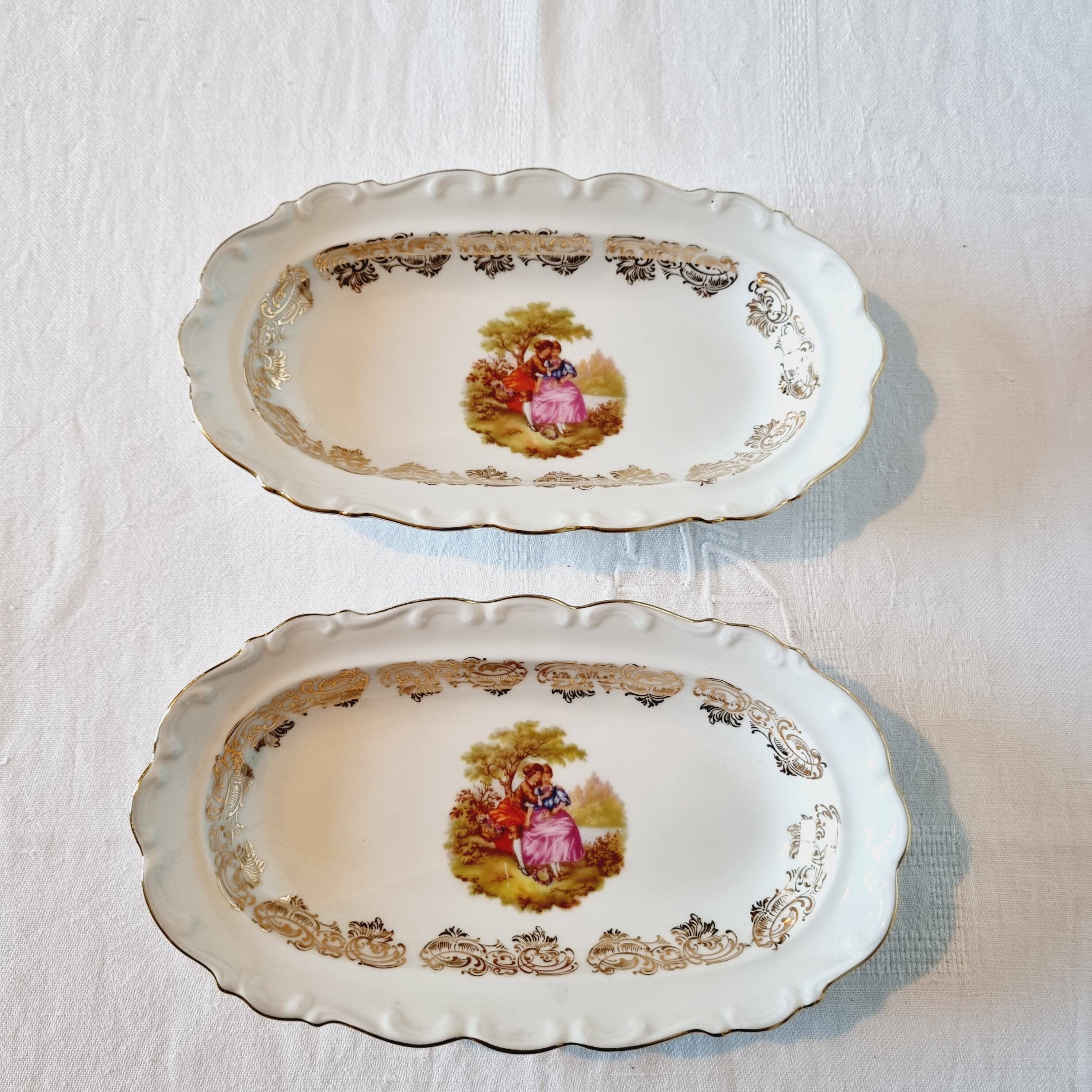 3 serving dishes with frangonard romantic scene with designs and borders in 24 carat gold.