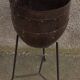 Old metal pot on foot
