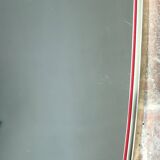 Vintage 1960s mirror in a freeform shape with a gold and red trim.