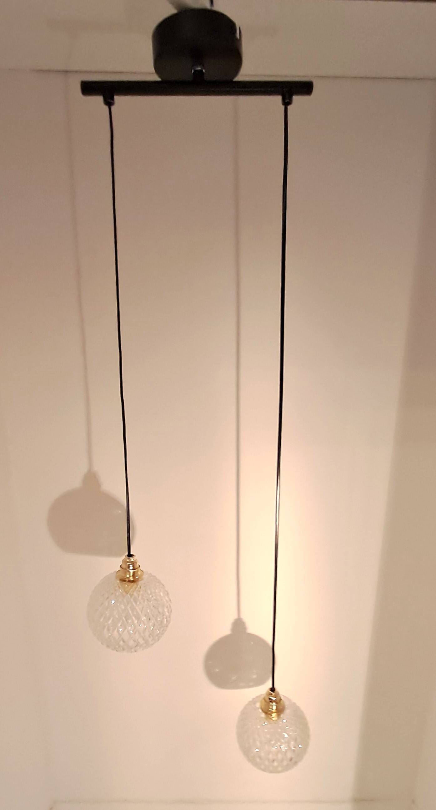 Two-light pendant in a cascade of cut crystal globe