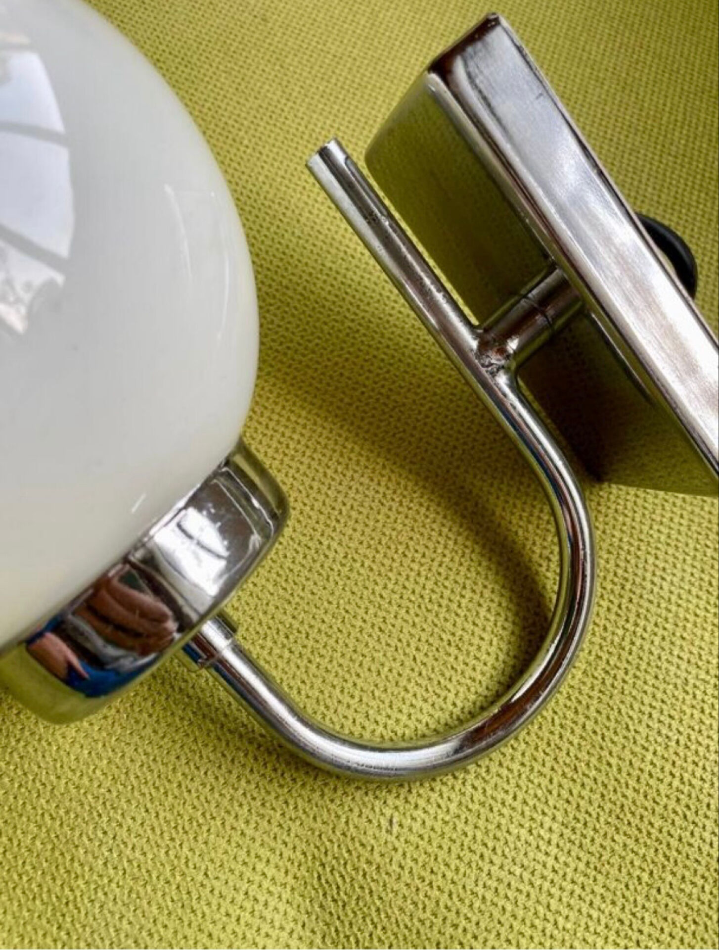 Pair of chrome metal wall lights with white glass globe.