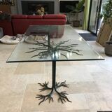 Wrought iron table with tree sculpture and glass top