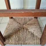 Antique campaign stool in solid wood with a straw seat.