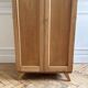 Small oak cabinet with tapered legs.
