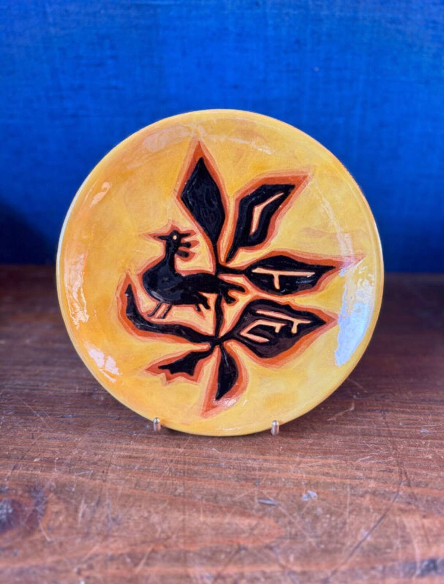 Terracotta plate, Jean Lurçat decorated with a rooster and foliage.