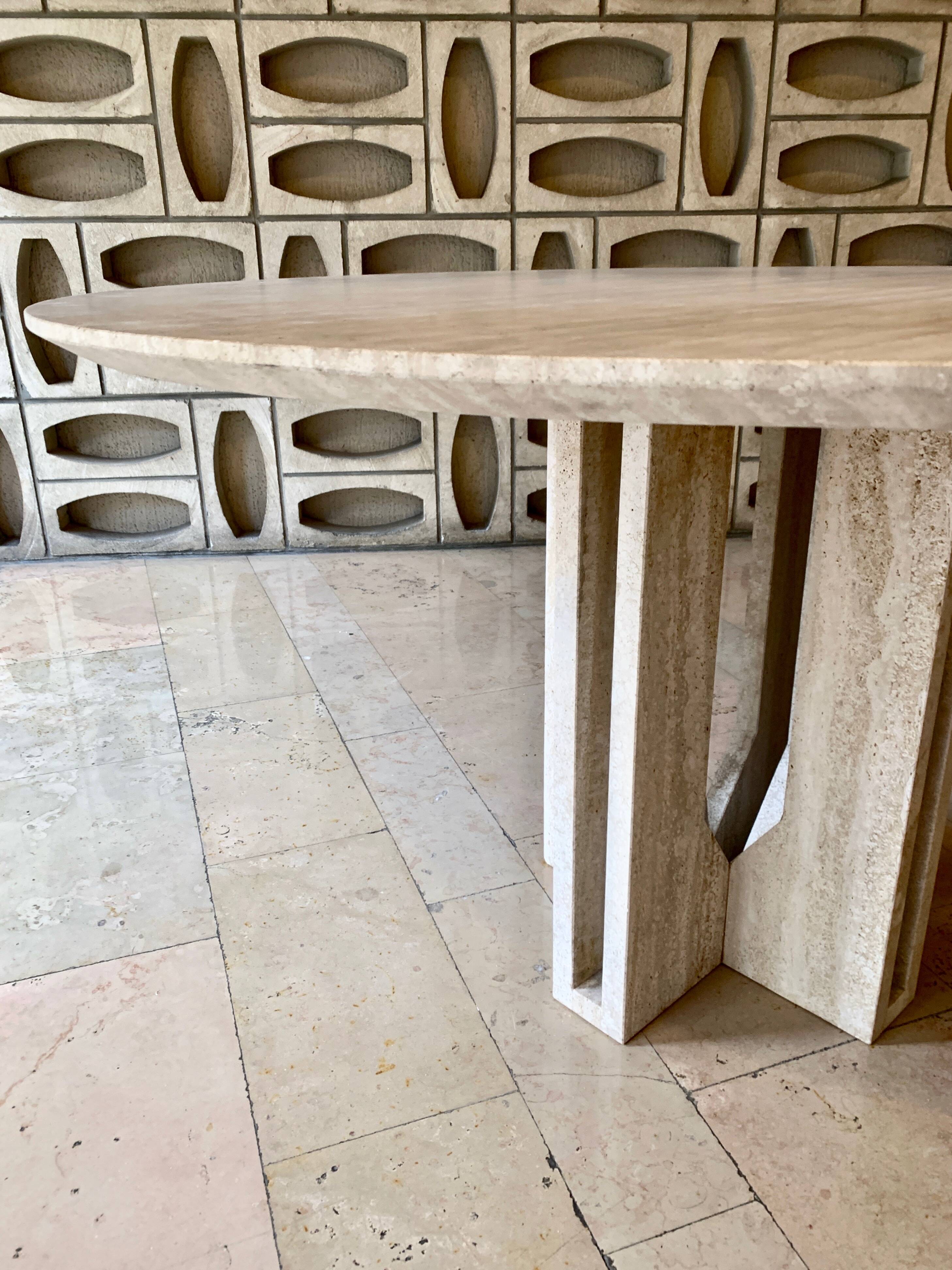 Round travertine dining table by Claude Berraldacci