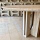 Round travertine dining table by Claude Berraldacci