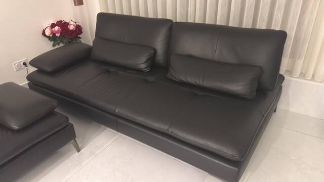 2 black leather sofas roche bobois scenario, one three-seater and one chaise longue.