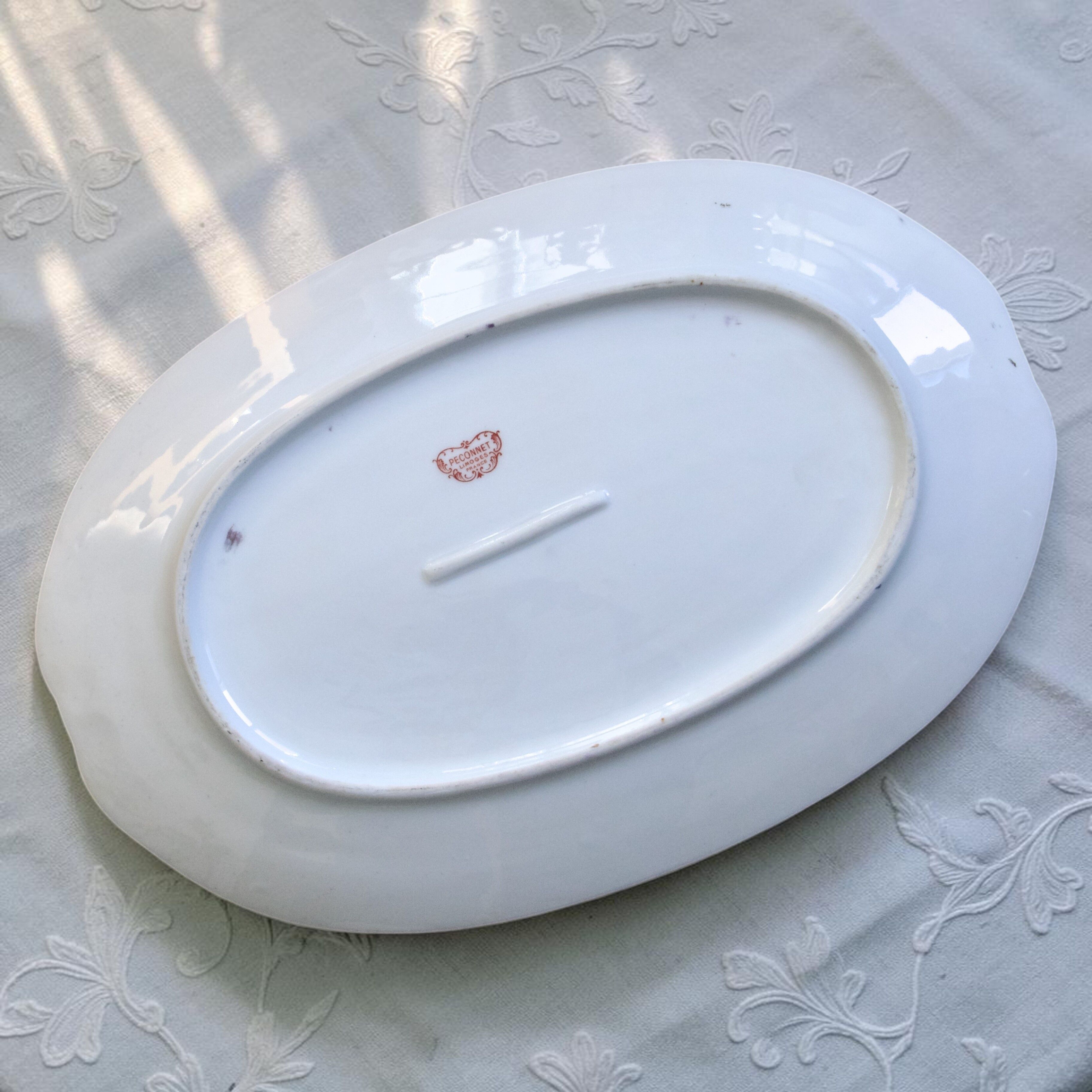 Large oval dish with gold trim in Limoges porcelain by Peconnet.