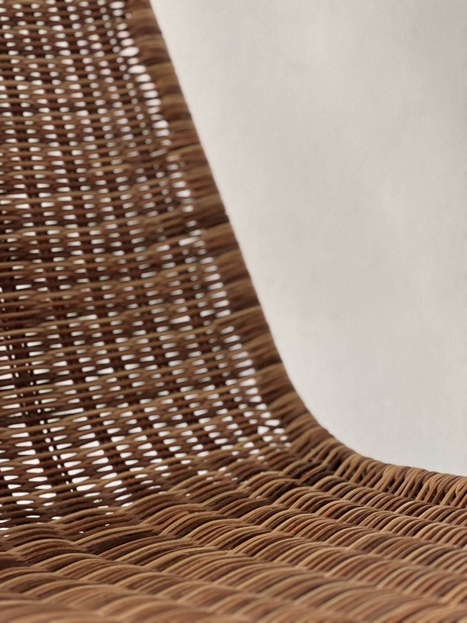 Chair design in rattan, woven wicker and chrome wire metal.