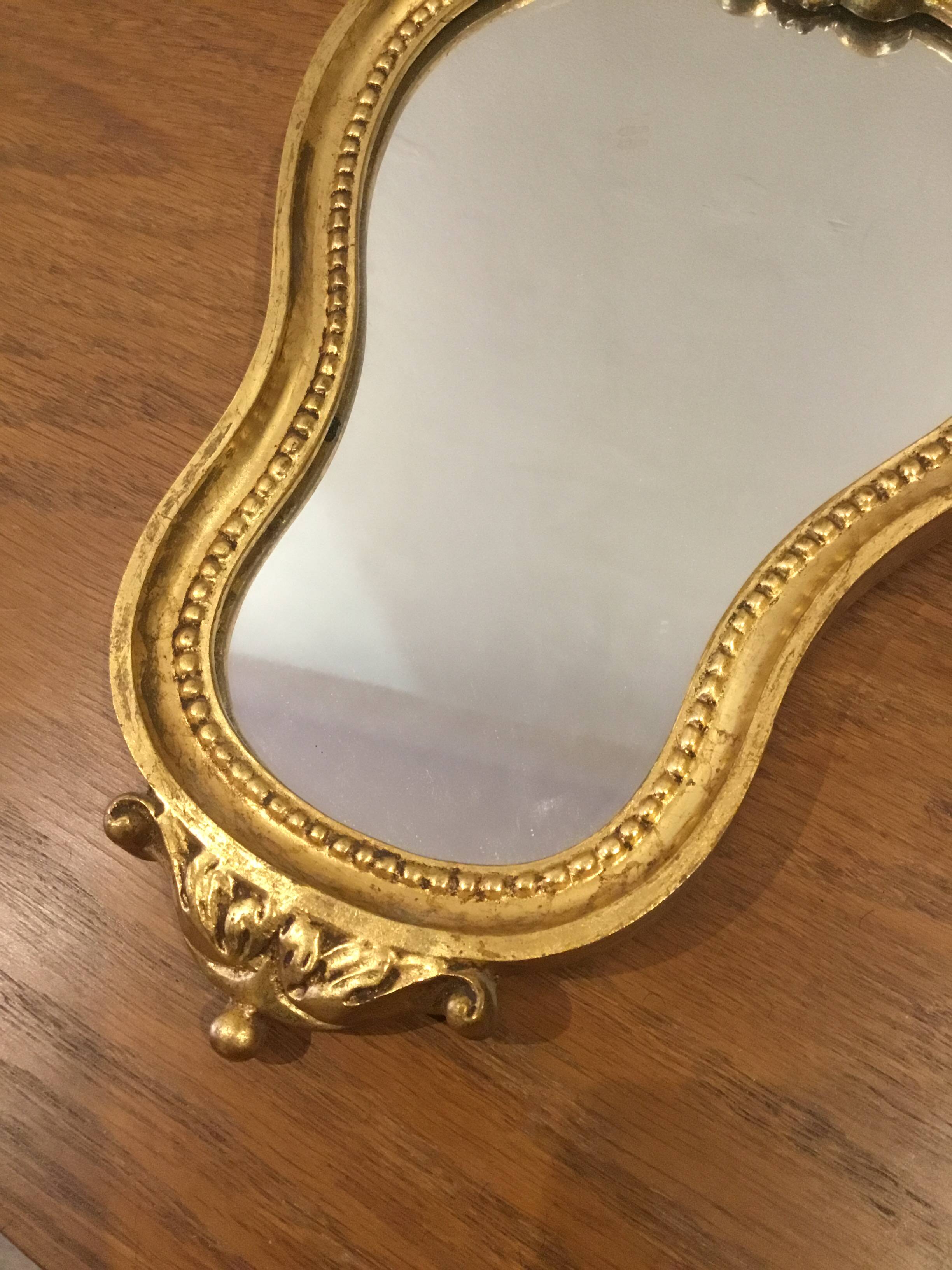 Golden wooden mirror in baroque style