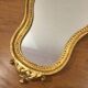 Golden wooden mirror in baroque style