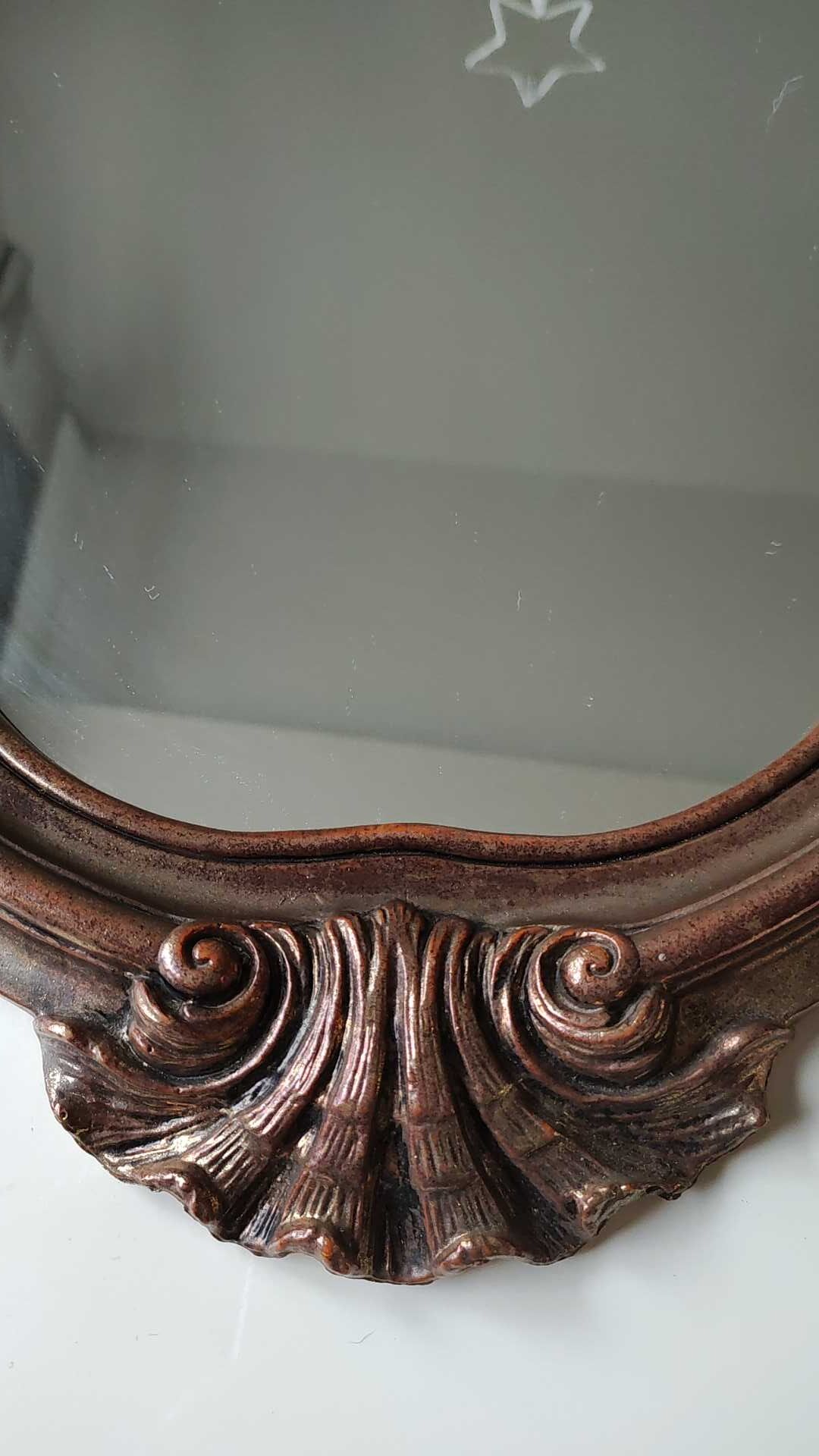 Pretty Baroque style mirror / Louis XV patinated with pink / golden copper reflections. Volutes, leafy shells