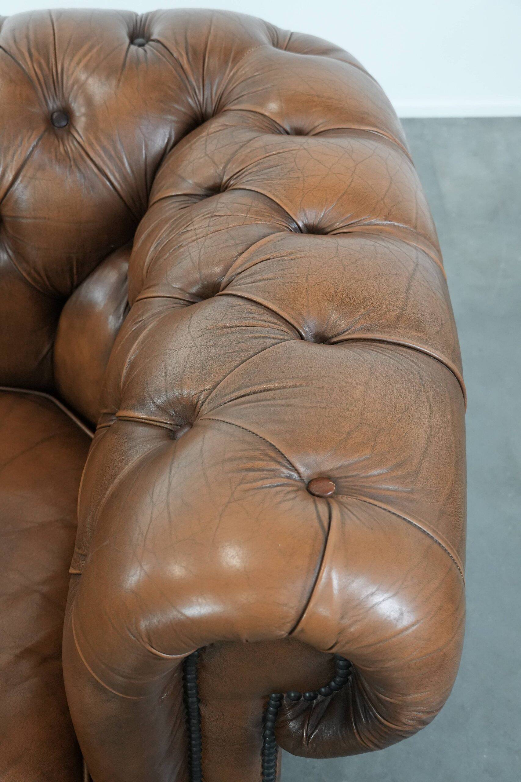 Brown cowhide leather chesterfield armchair  in English style on wheels