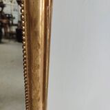 Long wooden mirror and gilded stucco with pearl rays H: 2m45 L: 40cm