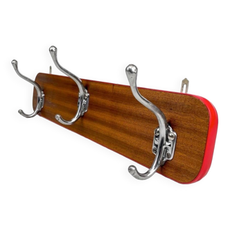 Metal and wood coat rack with red singing from the 60s