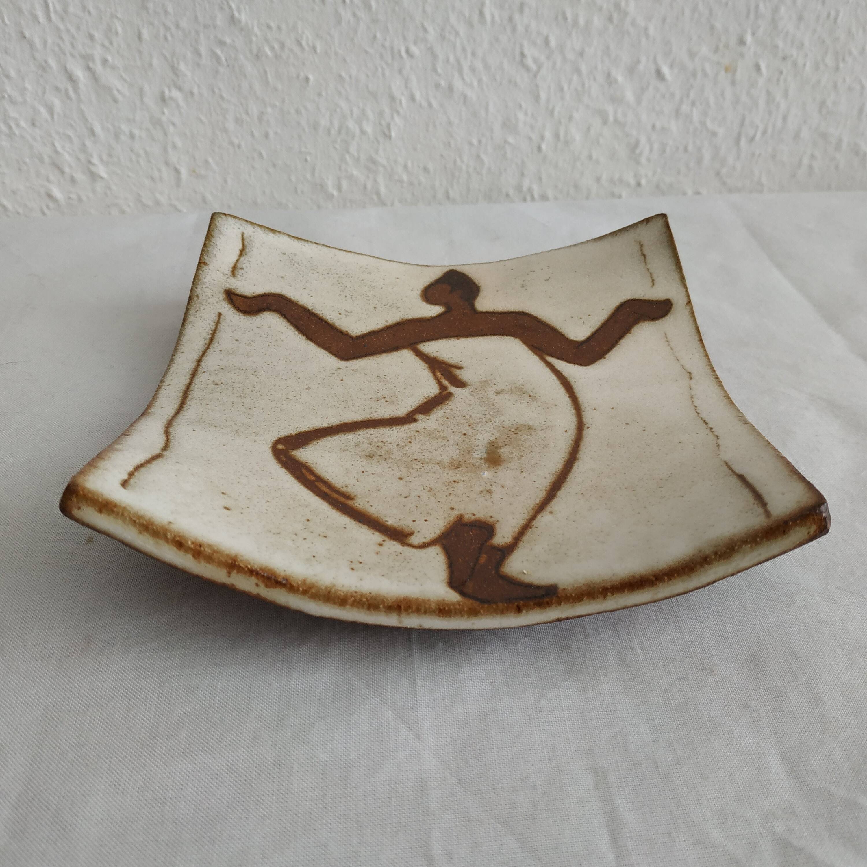 Two terracotta bowls with ethnic decoration and vintage signature.