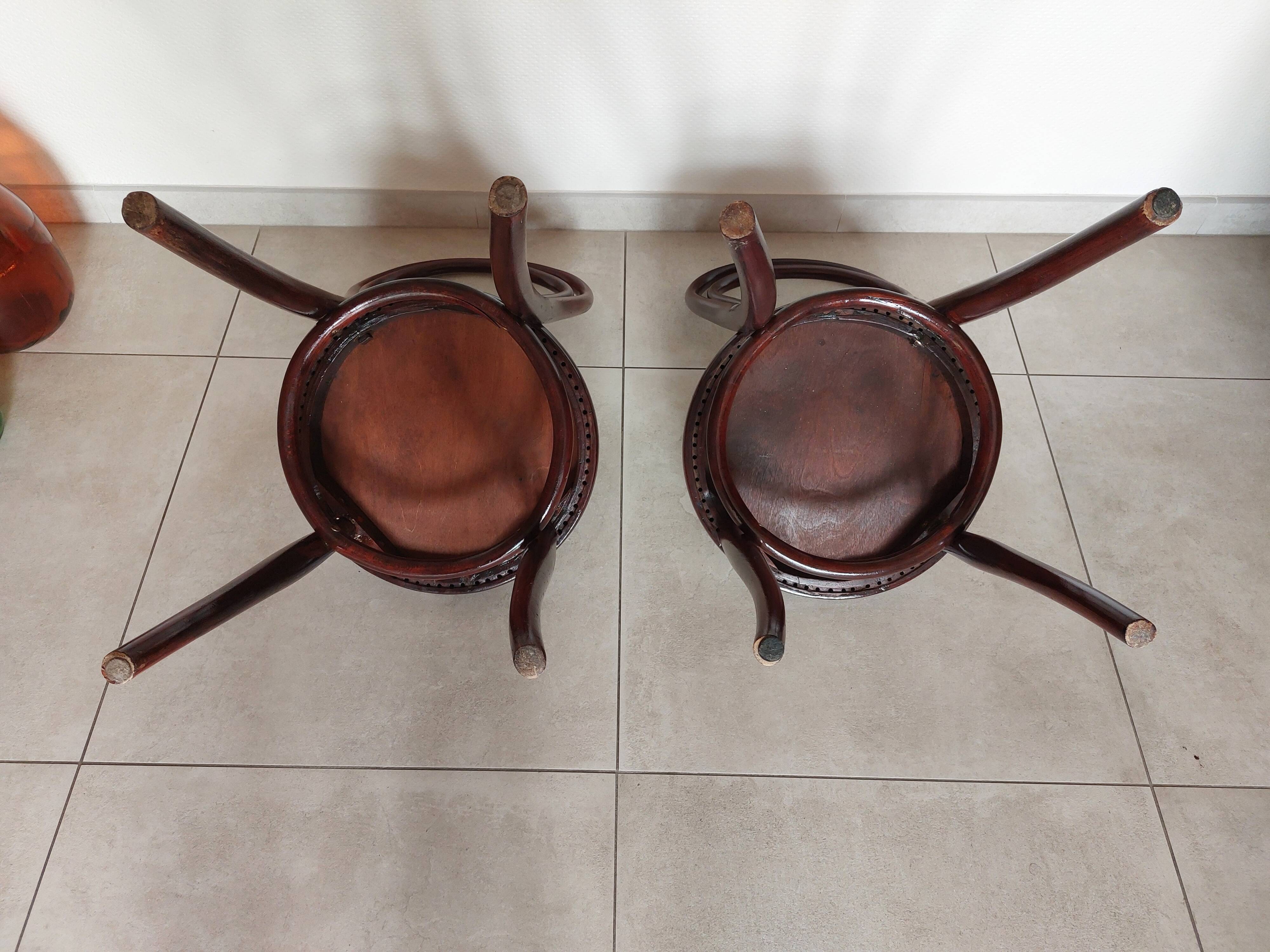 pair of round bistro chairs with a pattern on the seat, vintage