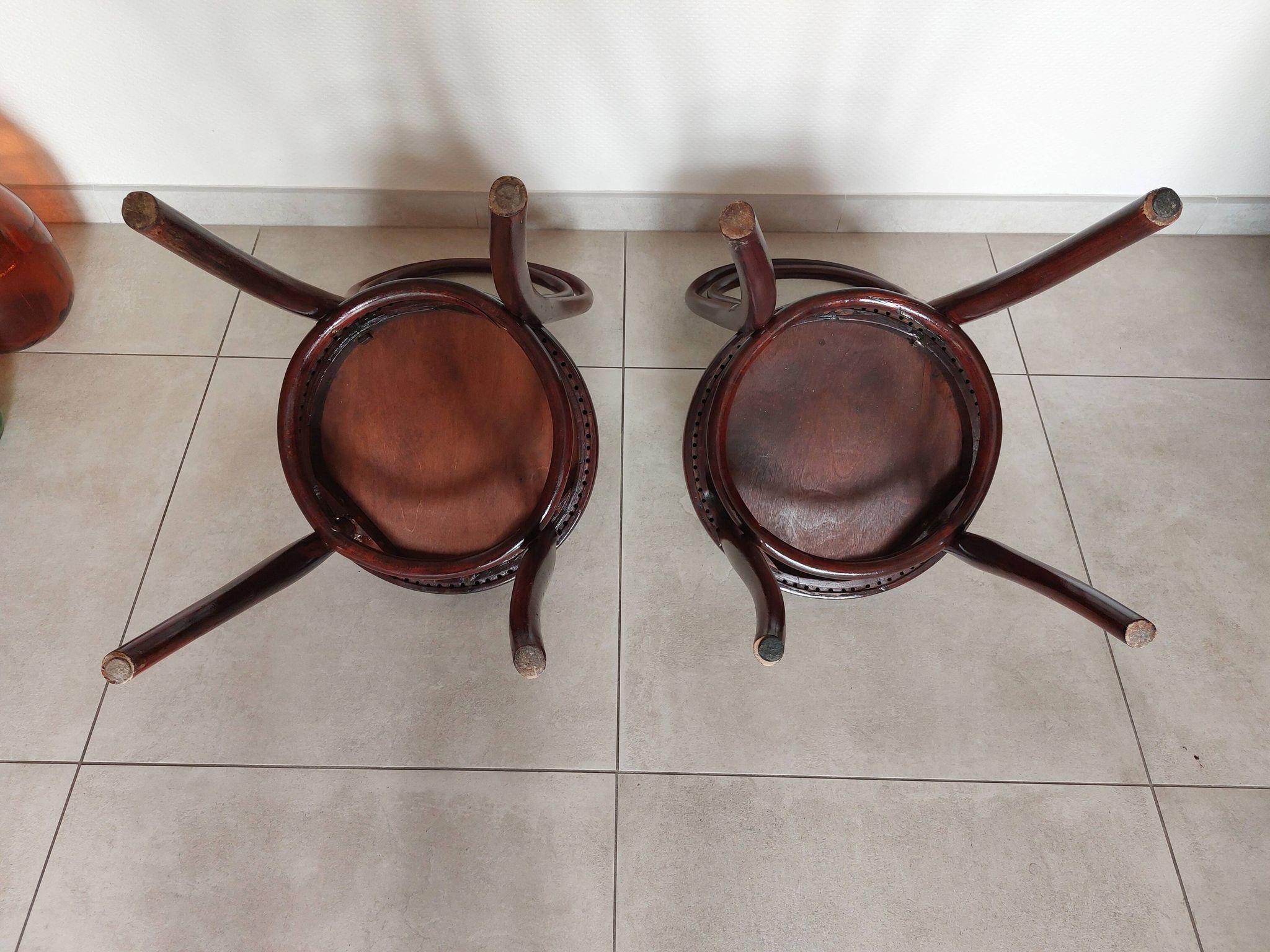 pair of round bistro chairs with a pattern on the seat, vintage