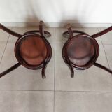 pair of round bistro chairs with a pattern on the seat, vintage