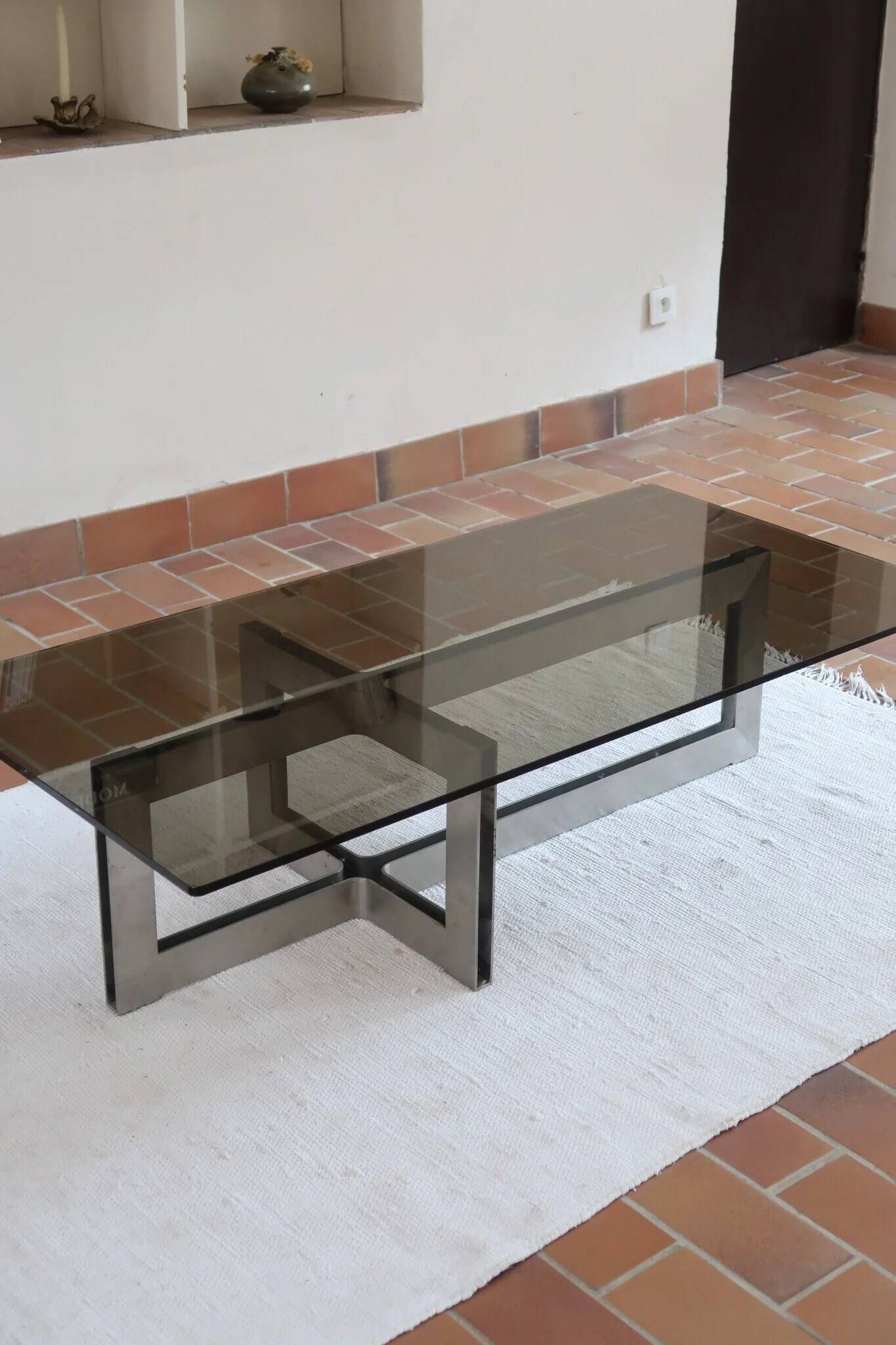 Smoked glass coffee table, brushed stainless steel base, 1970s.