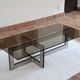 Smoked glass coffee table, brushed stainless steel base, 1970s.