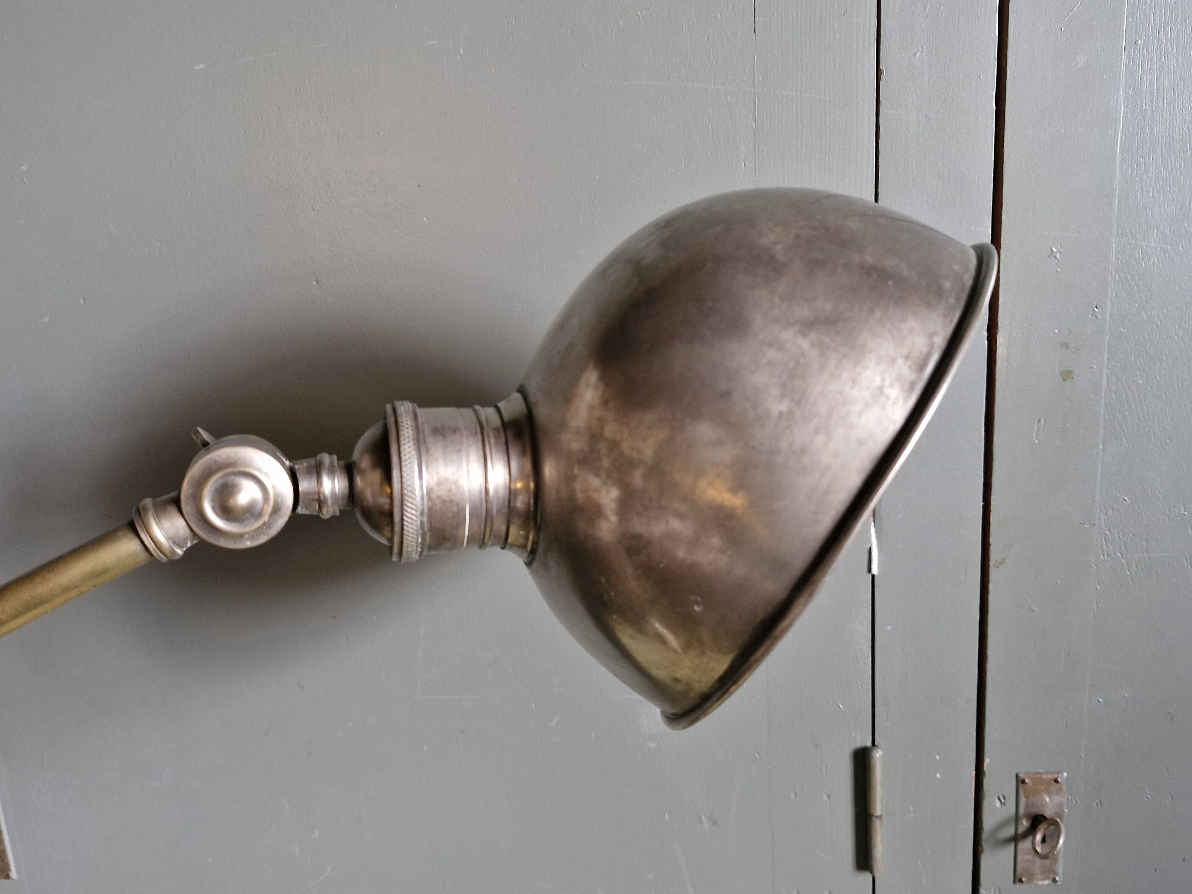 Old adjustable industrial lamp in bronze with 2 arms.