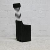 Brutalist chair, black-stained raw wood, steel. Work from the 1970s