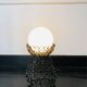 Handcrafted wrought iron lamp with a white opaline globe.
