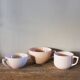 A set of 3 pink earthenware cups from Digoin Sarreguemines.