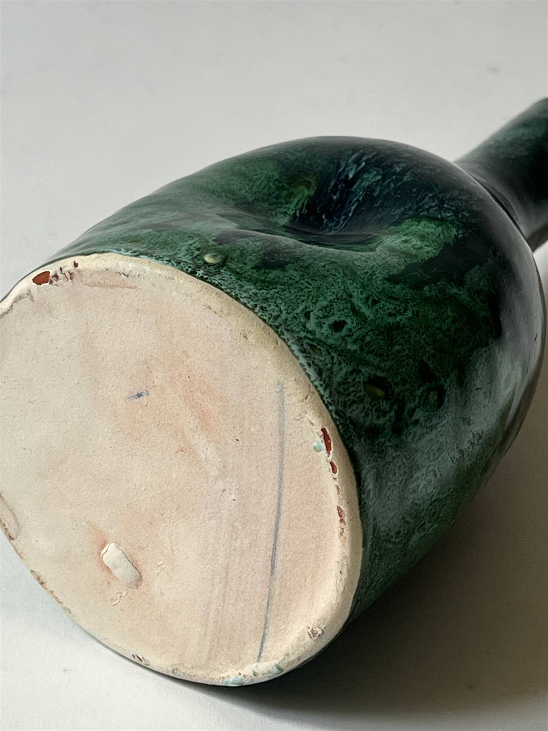 Ceramic vase with a glazed blue/green finish.