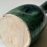 Ceramic vase with a glazed blue/green finish.