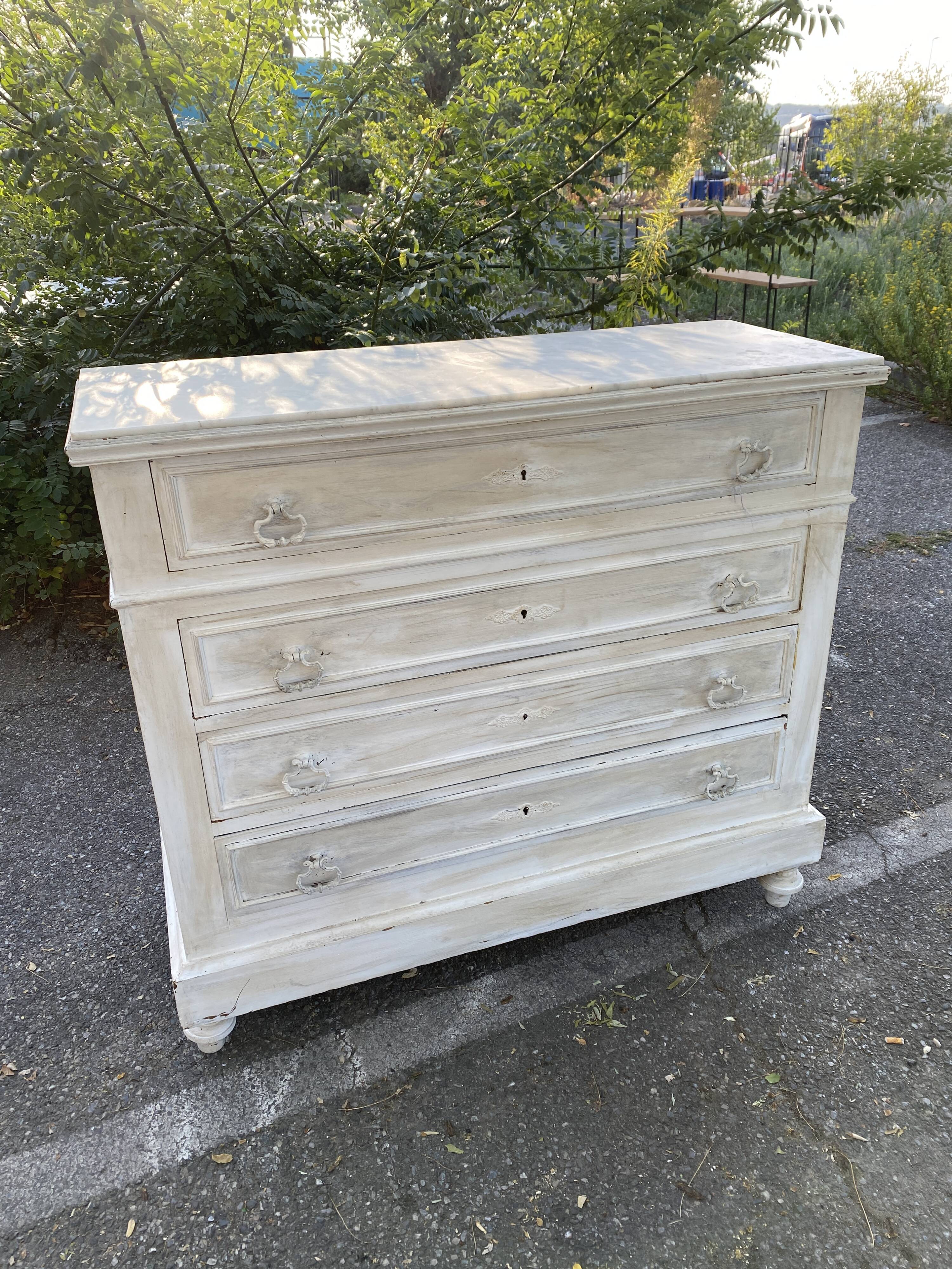 Old chest of drawers in bleached wood with white marble top