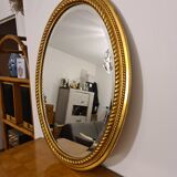 Beveled oval mirror in gilded wood 78×58cm
