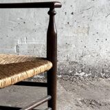 Dark brown solid wood Arts & Crafts armchair with natural rush seat and high back