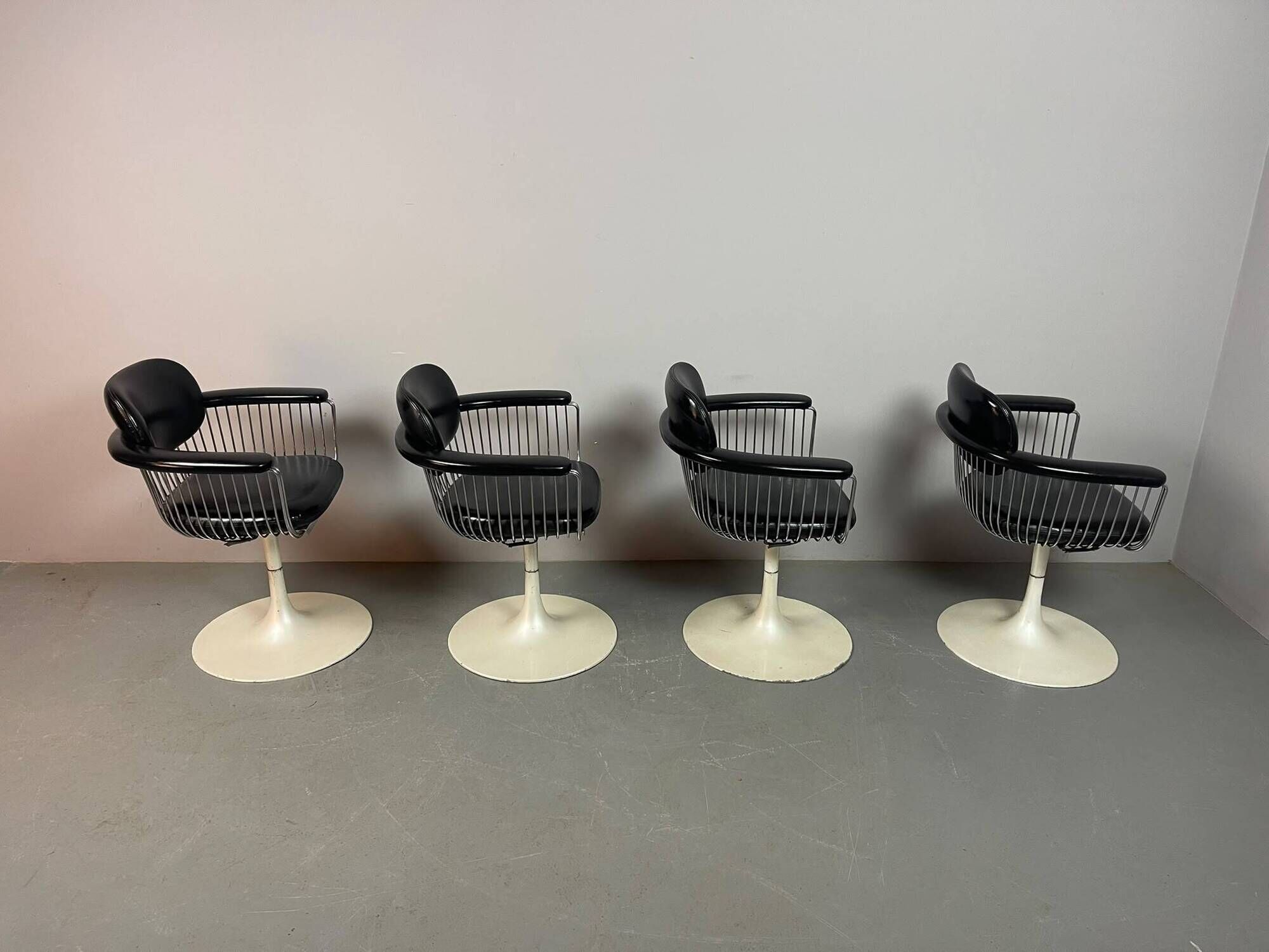 A striking set of four vintage swivel dining chairs